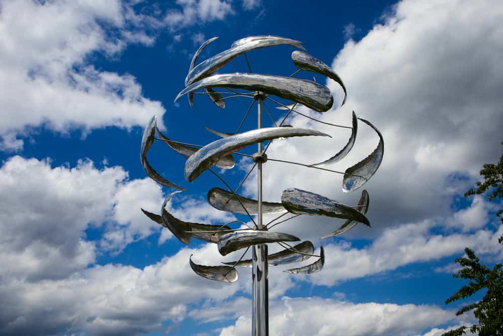 A closeup shot of a wind kinetic sculpture on a cloudy sky background