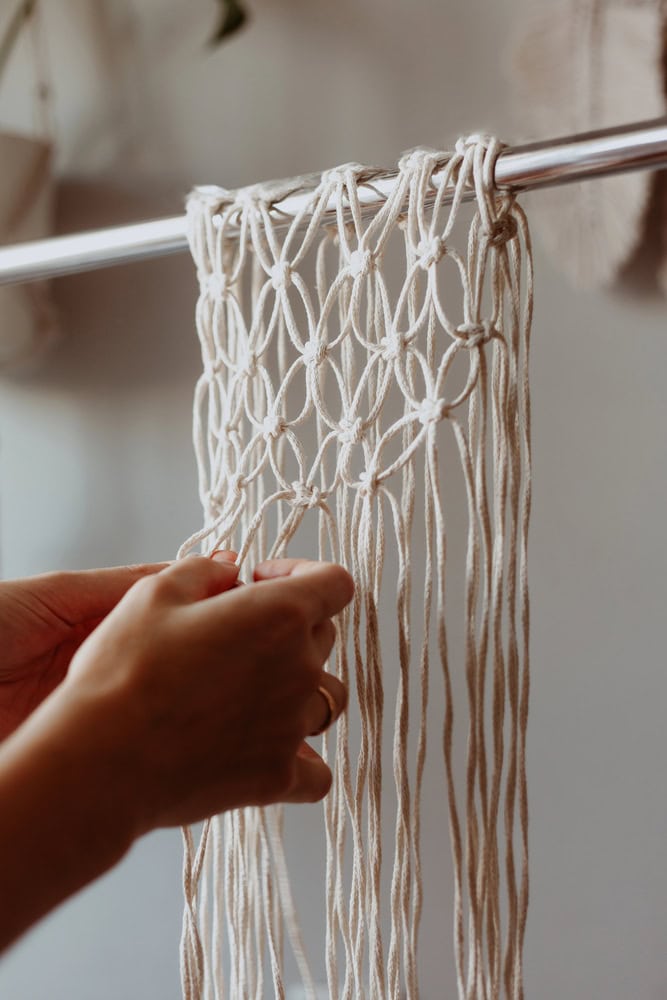 Hands tying knots for macrame for beginners plant hanger project